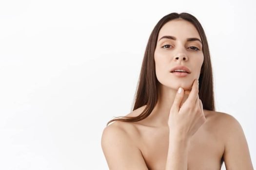 woman-with-natural-makeup-healthy-skin-portrait-beautiful-female-model-touching-fresh-glowing-hydrated-facial-skin-white-wall-closeup-skin-care-concept_176420-38392